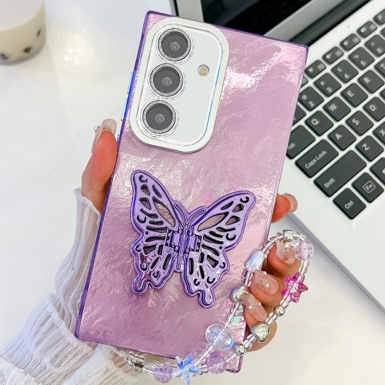 For Samsung Galaxy S25+ 5G Plating Glitter Lens Film Texture Butterfly Holder Wristband Phone Case(Purple Tinfoil Texture)