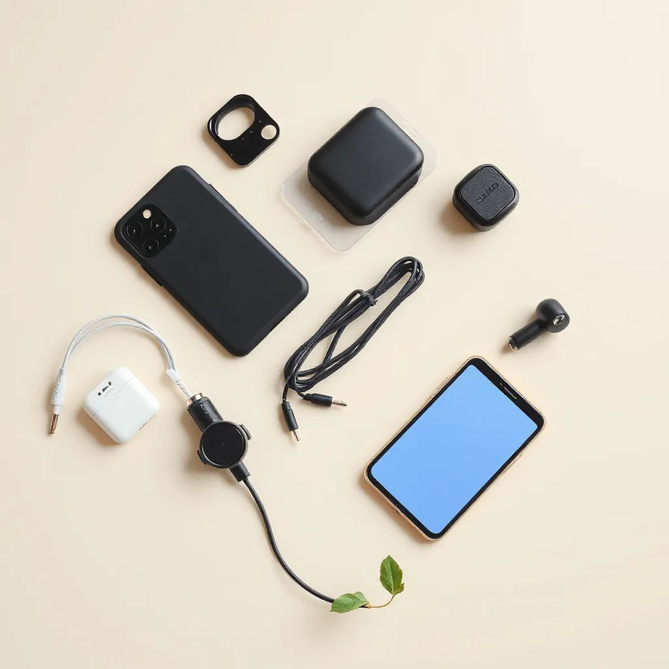 Assorted smartphone accessories laid out neatly with a wireless charger, case, cable, and earbuds