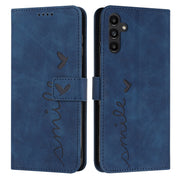 For Samsung Galaxy S25 / S24 5G Skin Feel Heart Embossed Leather Phone Case with Long Lanyard(Blue)