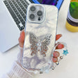 For iPhone 16 Pro Plating Glitter Lens Film Texture Butterfly Holder Wristband Phone Case(White Feathers) - iPhone 16 Pro Cases by PMC TechLife | Online Shopping South Africa | PMC TechLife | Buy Now Pay Later Mobicred