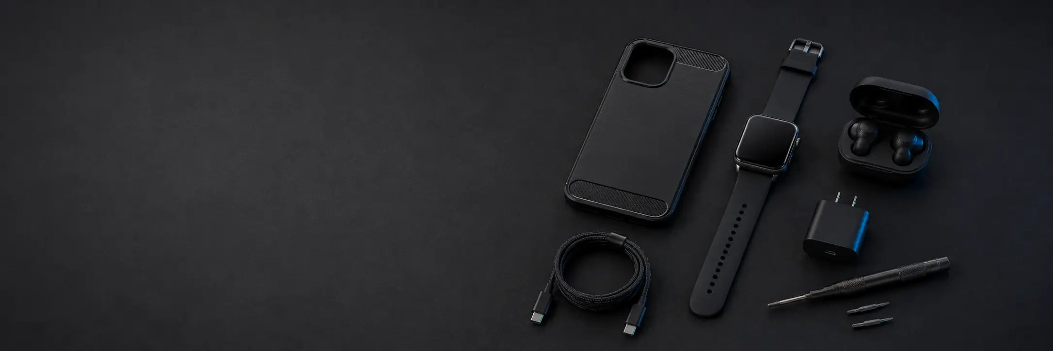Tech accessories and repair tools arranged on a dark surface